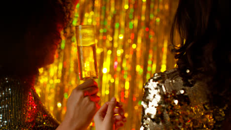 Close-Up-Of-Two-Women-Dancing-In-Nightclub-Bar-Or-Disco-Drinking-Alcohol-With-Sparkling-Lights-13